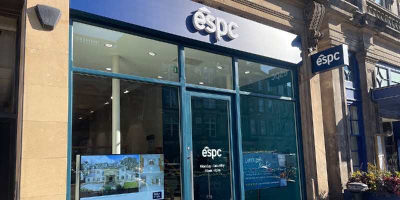 The storefront of a real estate agency with a sign displaying the name ESPC.