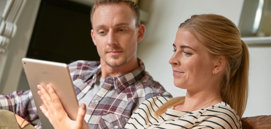 Couple holding tablet