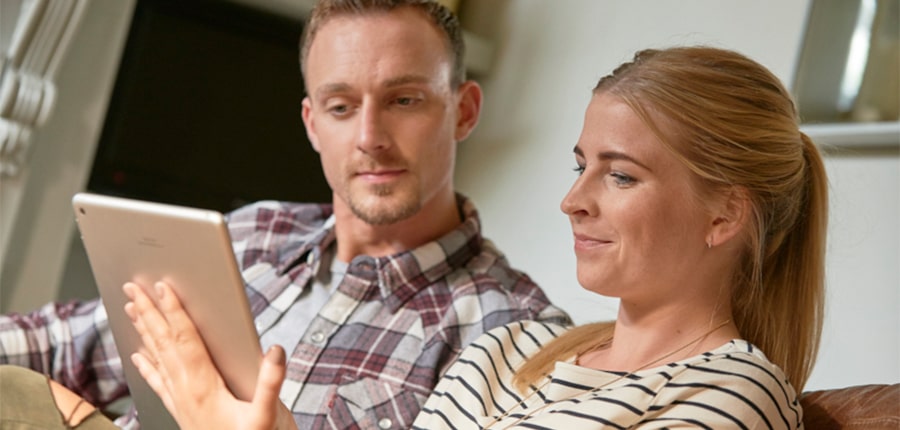 Couple with tablet looking at mortgages