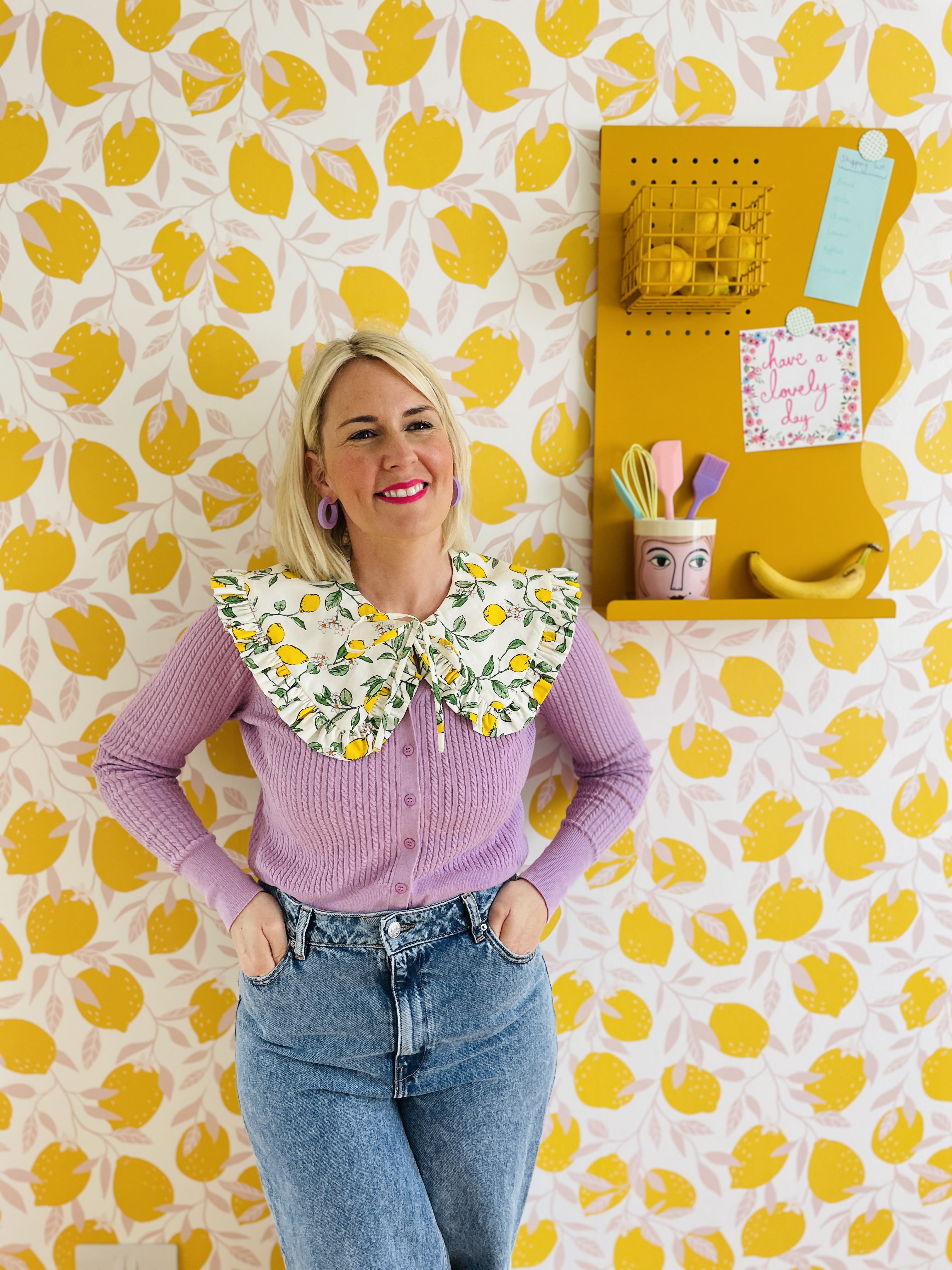 Woman in front of lemon print wall