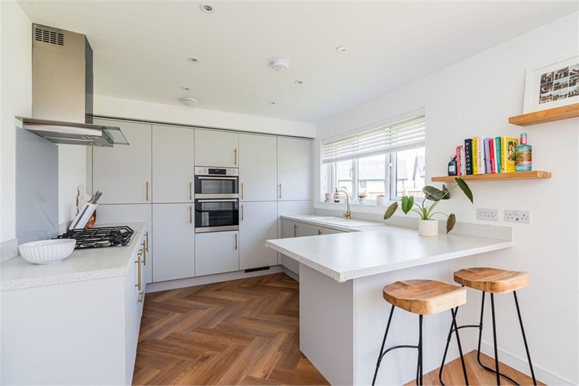 Open-plan kitchen with breakfast bar in ESPC listed property