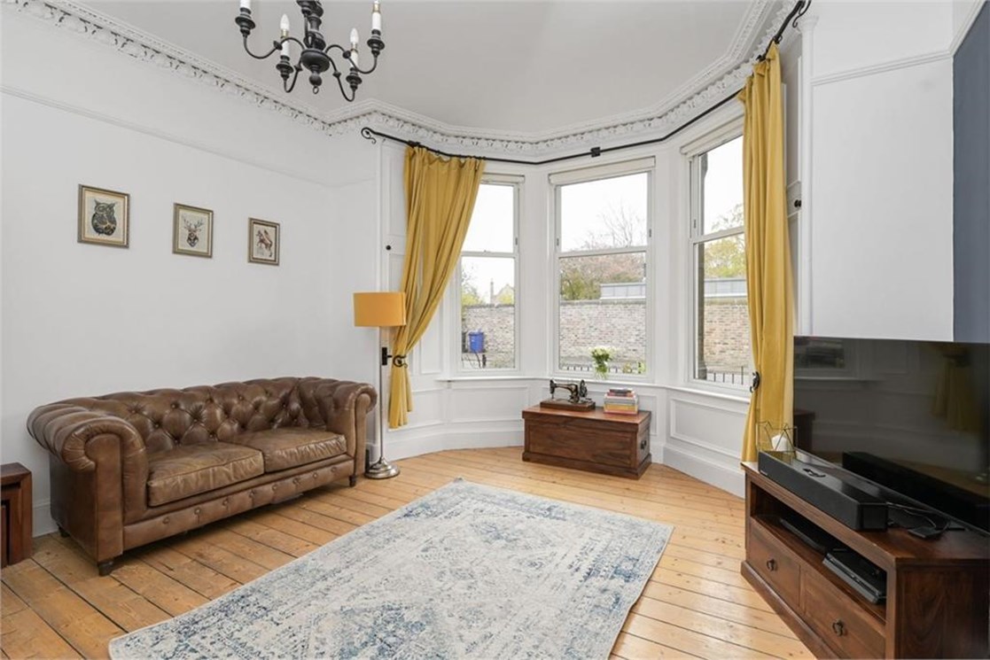Living room with wooden floors and large bay windows listed on ESPC