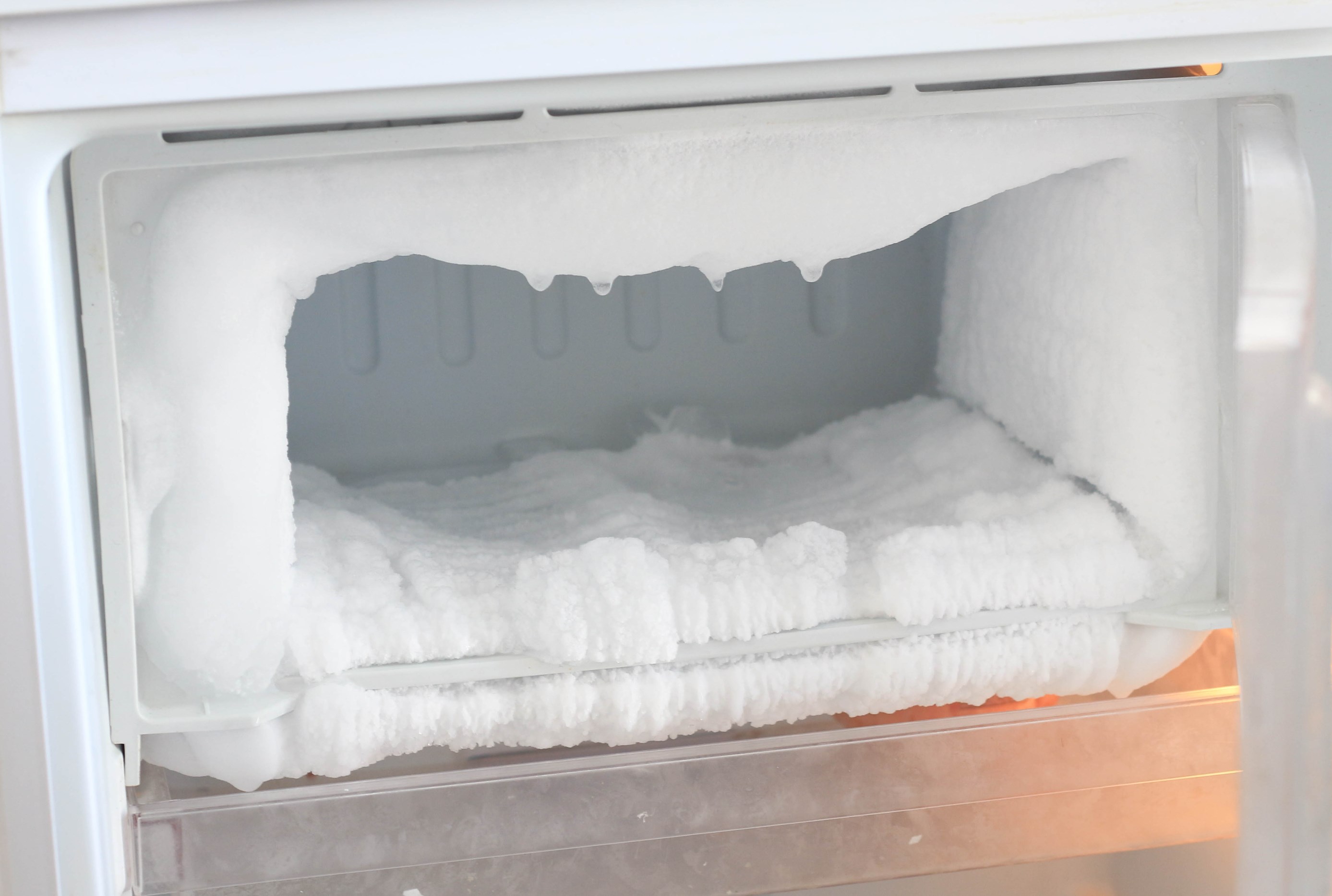 Empty freezer that needs defrosting